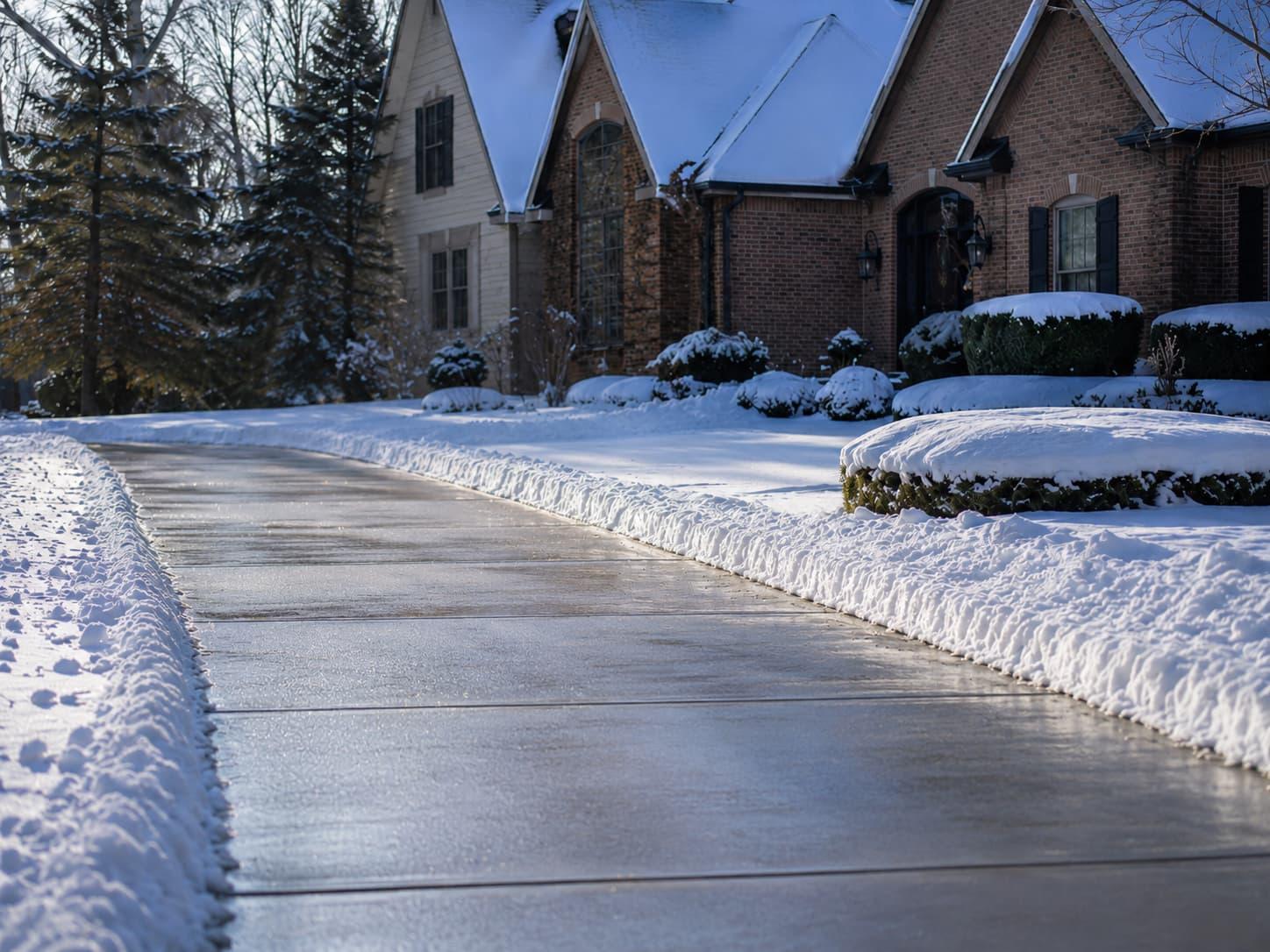 Snow removal equipment clearing a residential driveway